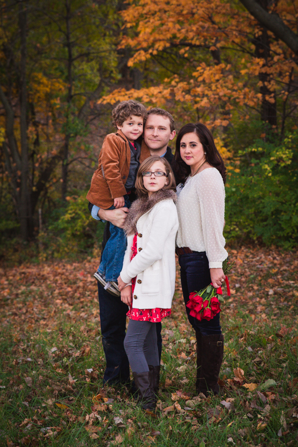 Family portrait of parents and two children in fall foliage, outdoor session, Liberty MO