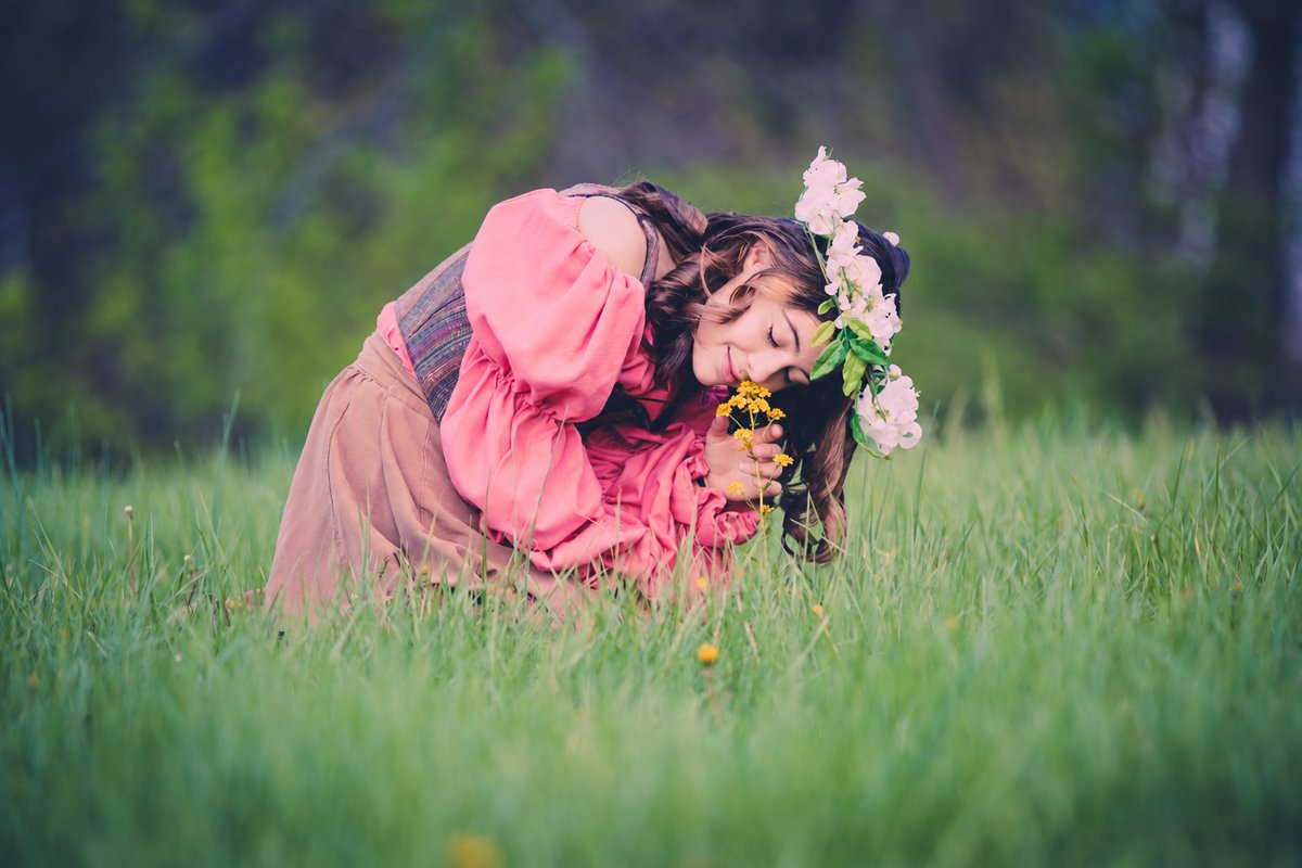 Senior wearing a flower crown in a green meadow
